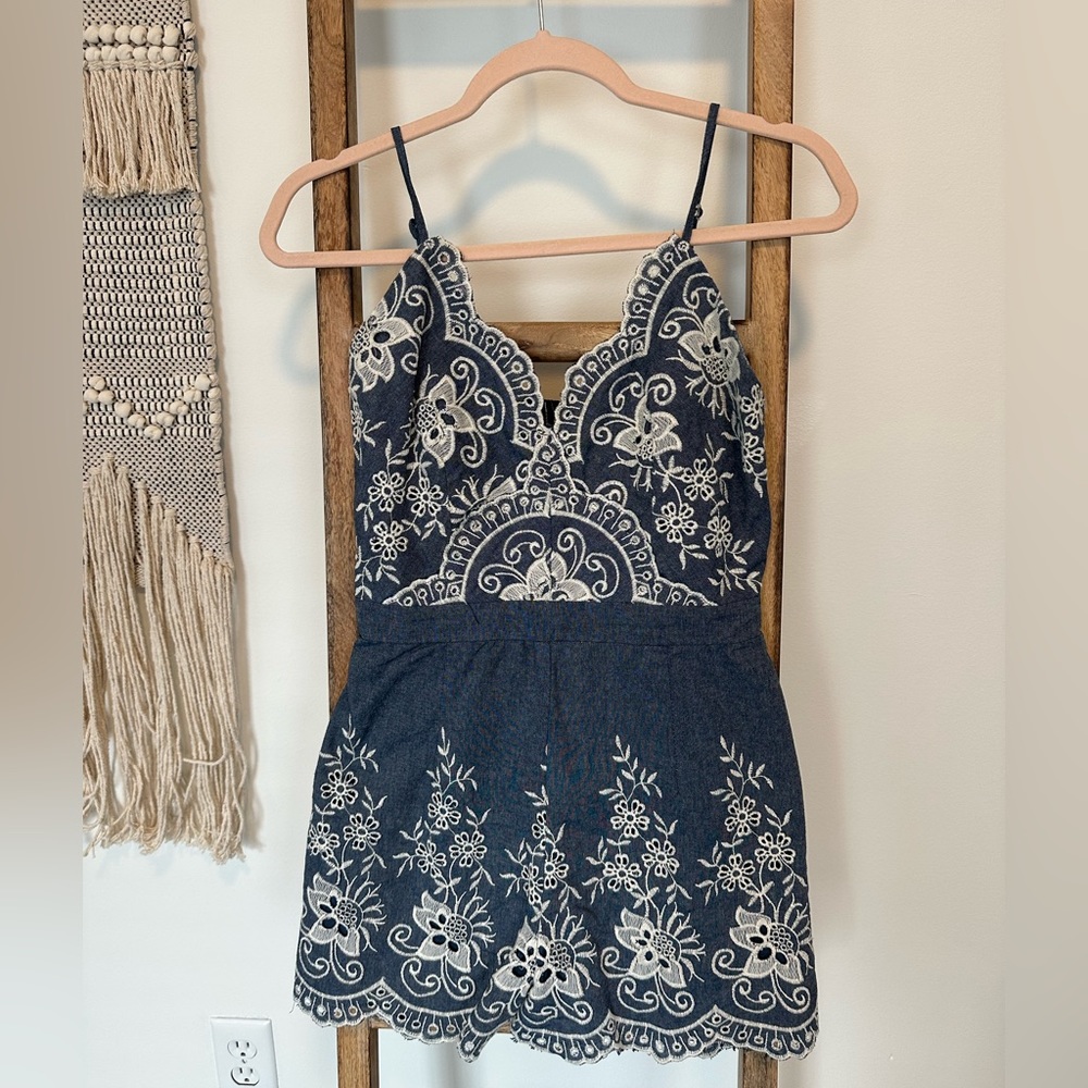 Denim and white romper with adjustable spaghetti straps. Incredible detail!